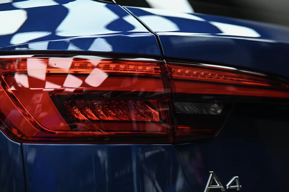 尾燈與 A4 車型銘牌特寫，燈殼與烤漆界線分明